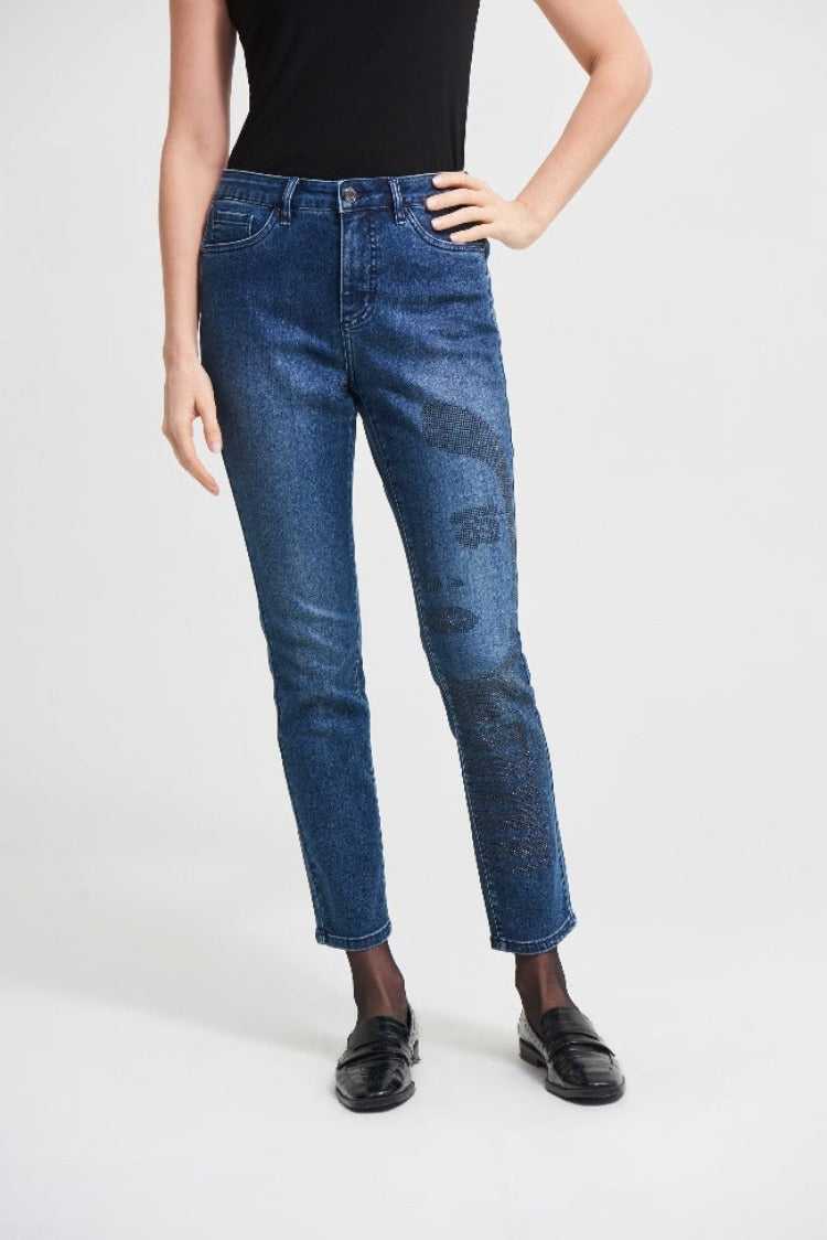Bring that posh city style home with these Joseph Ribkoff Denim Pants! These slim-fit, straight leg jeans feature an art-insipired rhinestone facial design on the leg, making these a truly unique pair of jeans. For maximum impact, pair these with a bold top or jacket. 
