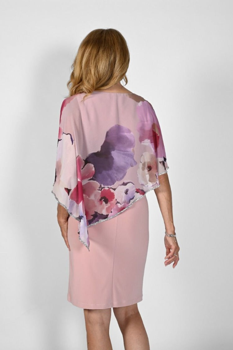 Frank Lyman Floral Overlay Dress Style: 232204 The Frank Lyman Floral Overlay Dress is an ensemble of both luxurious and comfort elements, crafted to perfection with a comfort fit and jersey underlay. The V-neck chiffon overlay creates a graceful, yet dramatic silhouette with its cold shoulder short sleeves and dazzling diagonal rhinestone edging. A perfectly lined piece to add a touch of sophistication to any occasion.