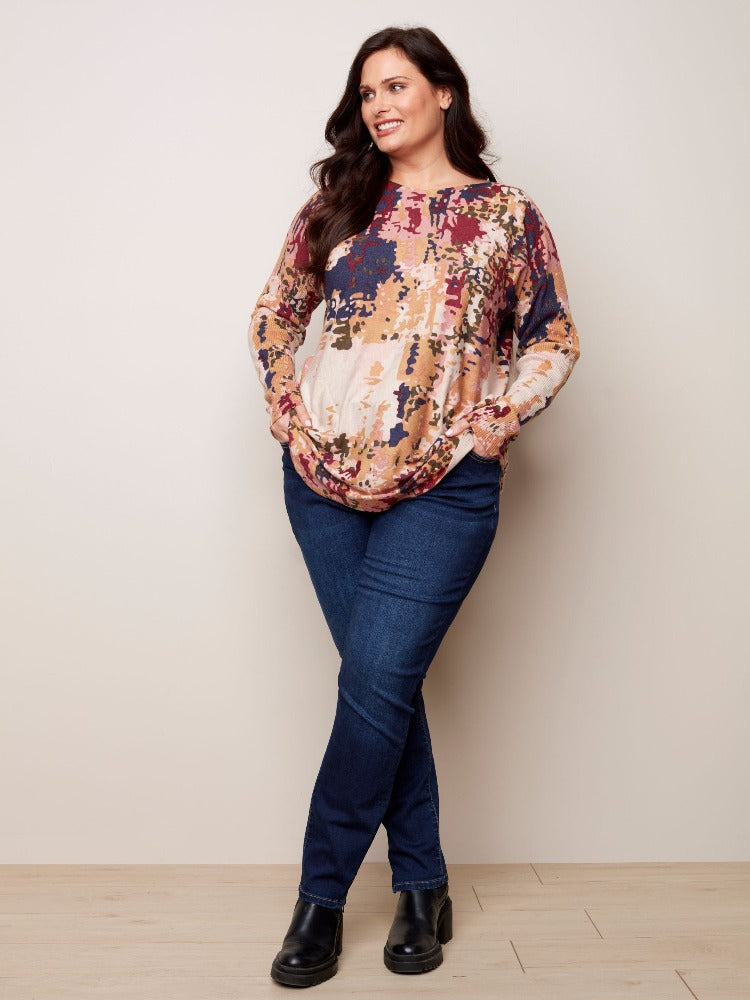 This tunic-length Charlie B Plus Long Sleeve Printed Sweater has so much for you to love. Super comfy material, a rounded hem, ribbed sleeves as well as an eye-catching tie-dye print and it even has pockets!