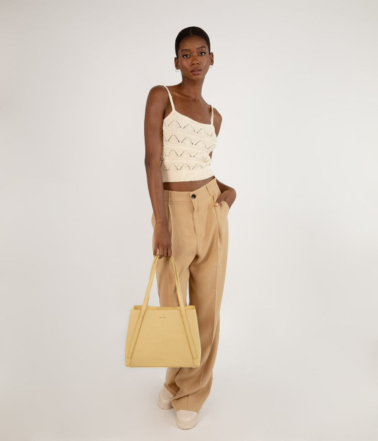 Matt & Nat ZOEY Tote Bag Tote with a triple compartment, Front and back slip compartments with magnetic snap closure, and a center zippered compartment. Interior: Zipper pocket and logo-embossed Purity patch. Dimensions: 12”L x 9.25”H x 5.5”D Handle Drop: 9.5” The outer body and lining of the Purity collection are made from recycled materials. All of the interior linings of our bags are made from 100% recycled plastic bottles. Our company is completely vegan and cruelty-free.