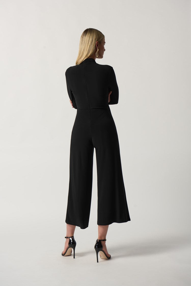 Joseph Ribkoff Wrap Culotte Jumpsuit  Style: 233097  Make a statement with this one-of-a-kind Joseph Ribkoff jumpsuit. Wrapped in luxurious fabric, it offers a flattering silhouette and ornamental buckle that adds a touch of glamour. The long sleeves and culotte pants elongate the figure while the zipper back makes it easy to slip on and off. Ideal for weddings, galas and more, this timeless piece will ensure you stand out from the crowd.