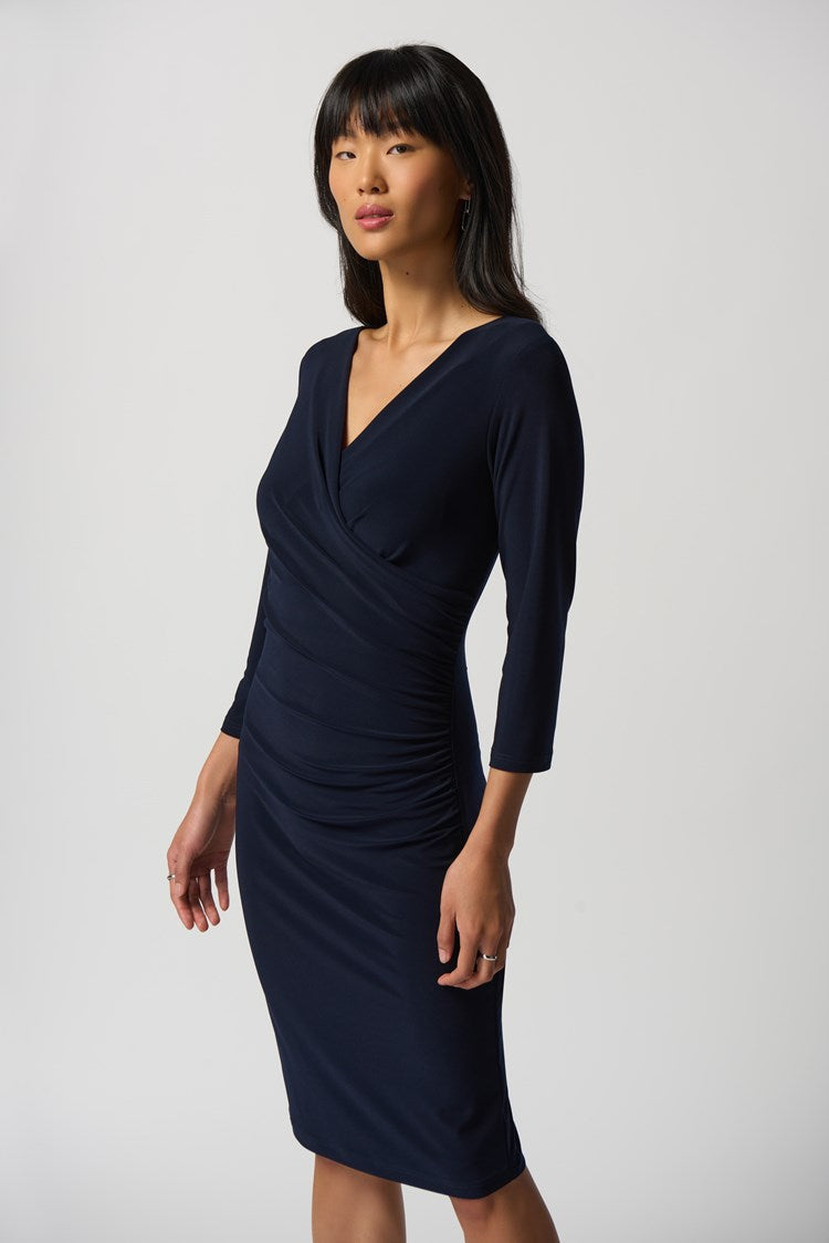 Joseph Ribkoff Three-Quarter Sleeve Wrap Dress  Style: 233305  This alluring wrap dress from Joseph Ribkoff is sure to lend timeless sophistication and subtle modern flair to any wardrobe. Crafted from a luxuriously soft silky knit fabric and featuring delicate waist pleats, it offers an elegant and flattering fit that is sure to make a statement wherever you go. Designed to end just above the knees, you can enjoy a timelessly chic look perfect for any occasion.