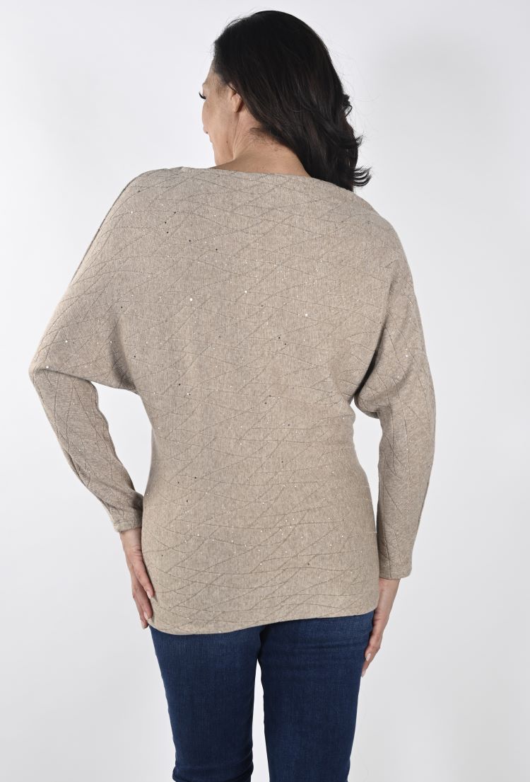This Frank Lyman top features batwing sleeves that gracefully hug the forearms, for an elegant pairing of comfort and style. Its unique texture exhibits a matte finish, with a visual texture through its wavy lines. Additionally, the waist and hips are fitted, outlining your silhouette.