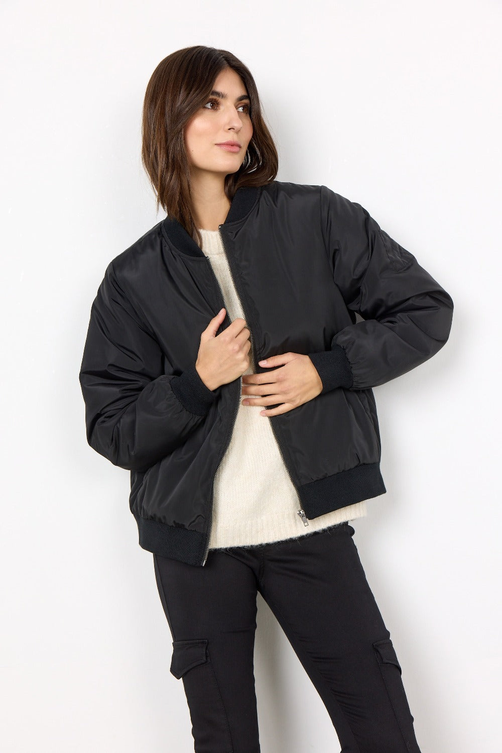 The Soya Concept Tilly Bomber Jacket is a perfect yet simple style for you to have in your wardrobe. With it's high neckline, a zipper, cropped design, a shine finish, and boxy fit you can toss it on as you are heading out the door with confidence.