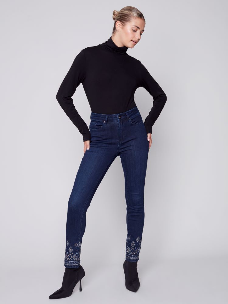 Elevate your seasonal wardrobe with Charlie B's Blue Black jeans. Exquisite geometric embroidery and embellishments adorn the hem, while a slim leg, regular rise and stretch material provide a comfortable fit with five convenient pockets.