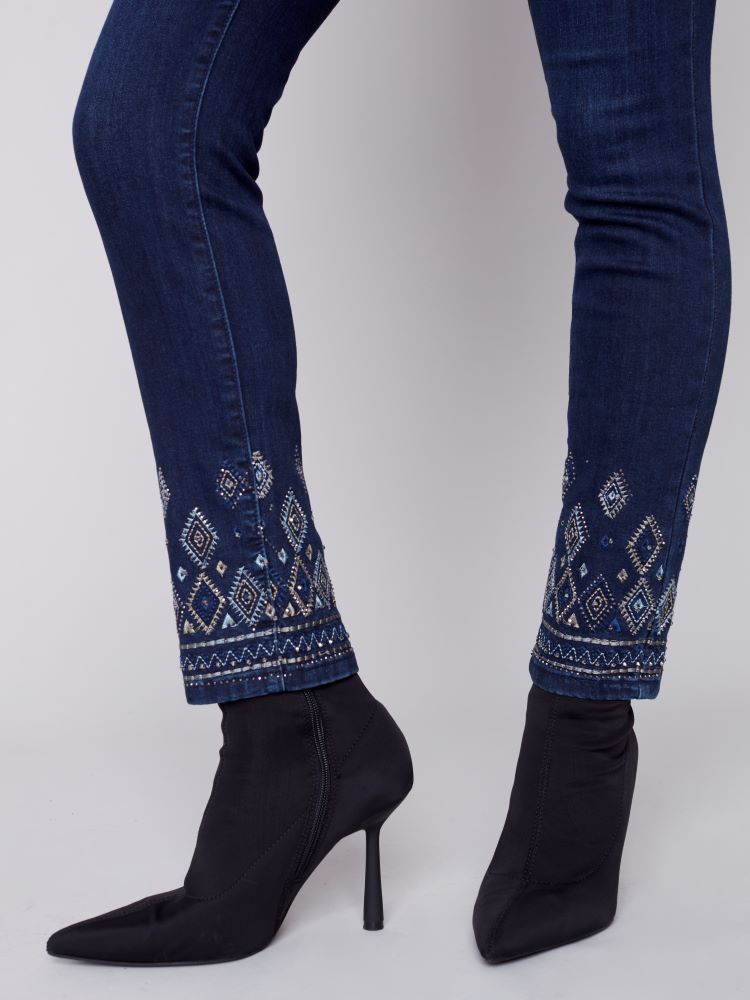 Elevate your seasonal wardrobe with Charlie B's Blue Black jeans. Exquisite geometric embroidery and embellishments adorn the hem, while a slim leg, regular rise and stretch material provide a comfortable fit with five convenient pockets.