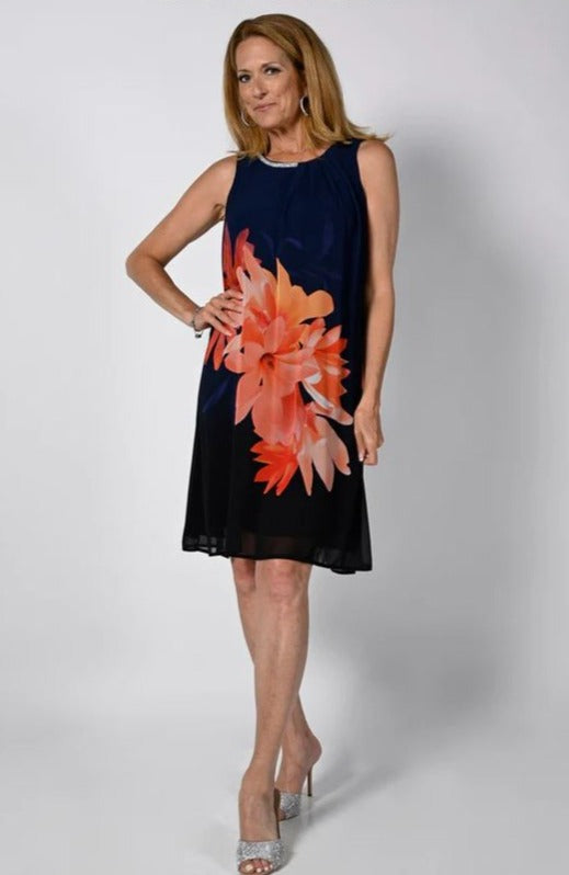Frank Lyman Floral Dress   Style: 238356  Fall in love with this luxurious Frank Lyman Floral Dress, with its elegant knit fabric adorned with a beautiful floral design. Its rounded neckline and sheer overlay create a fit that is flattering and elegant, and its stunning rhinestone detail at the back adds an extra touch of sophistication. Perfect for any occasion, this graceful dress radiates high-end fashion and luxury.
