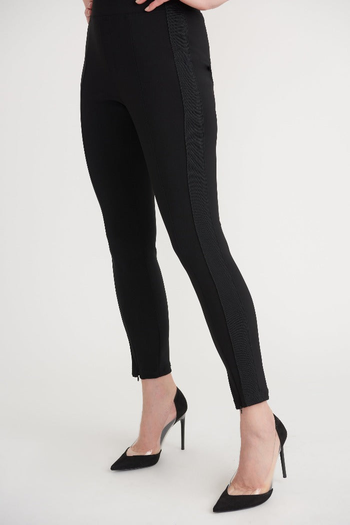Joseph Ribkoff Slim Dress Pants  Easy to wear with an elastic waist, these cropped black pants by Joseph Ribkoff have clean lines with appeal for any wardrobe. Hem falls at the ankle and is finished with zippers.