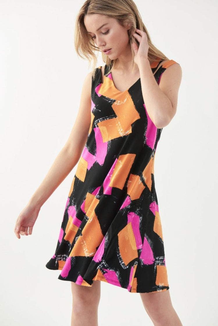 This Joseph Ribkoff Block Print Dress is both comfortable and colourful! This dress features sultry shoulder cutouts, a flirty a-line skirt, and pockets for all of your must-haves. The low-maintenance fabric makes this a great dress for travelling. 