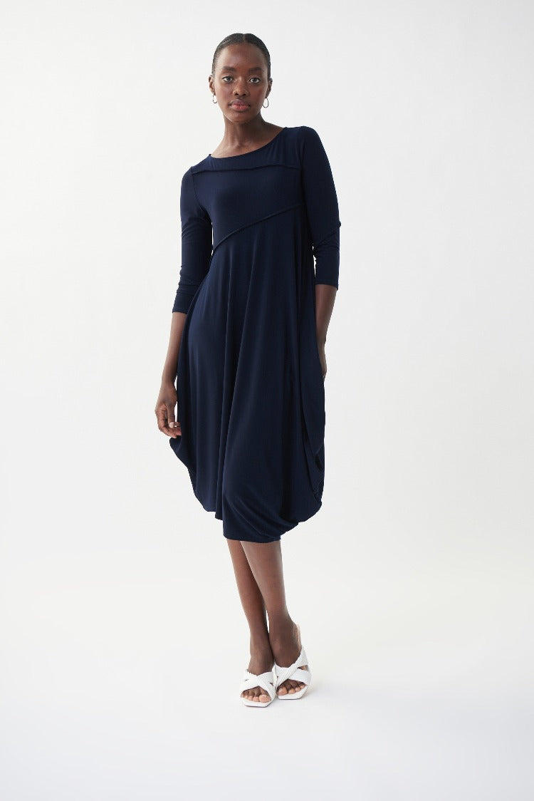 This Joseph Ribkoff Sleeveless Flowy Dress is an easy piece you'll love to wear again and again. With unique stitching on the bodice and arms, convenient 3/4 length sleeves and an angled, bubble-style hemline, this basic is the perfect throw-on dress.