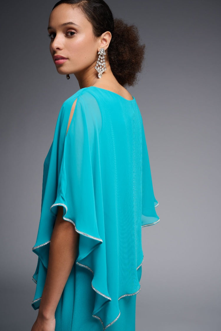 The flattering and feminine elegance of this Joseph Ribkoff Overlay Dress is the perfect choice for your special event. With striking asymmetrical chiffon overlay and rhinestone details, it gives you a fabulous striking silhouette.  