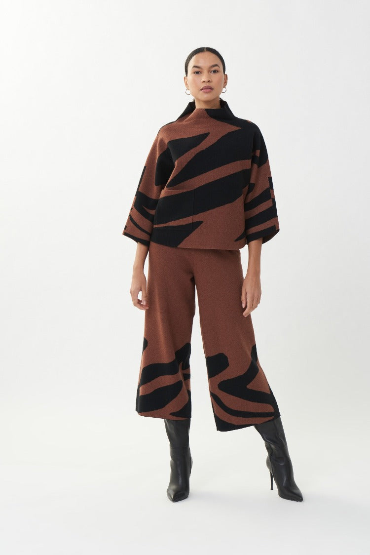 Look no further than this Joseph Ribkoff Printed Wide Leg Pant for that seasonal flair.  The fun animal print has a cropped wide leg and is a pull on style with elastic waist.  Bring out your fun style for work or nights out.