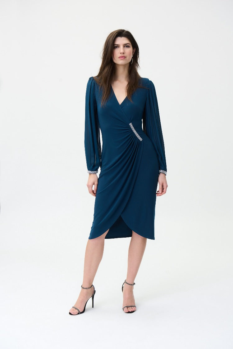 This beautiful Joseph Ribkoff Faux Wrap Dress gives you a classic and timeless style.  A fabulous choice for any occasion. The pleated balloon sleeves and beading details at the waist and wrist add a touch of glamour.