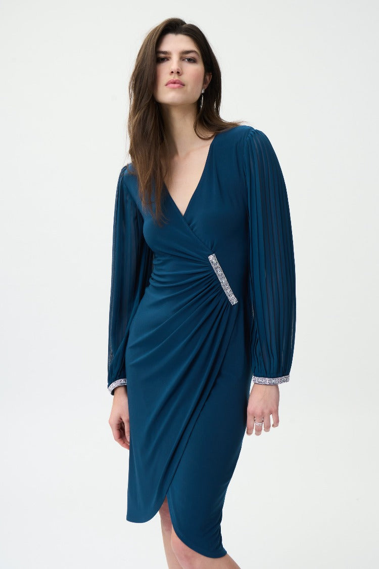 This beautiful Joseph Ribkoff Faux Wrap Dress gives you a classic and timeless style.  A fabulous choice for any occasion. The pleated balloon sleeves and beading details at the waist and wrist add a touch of glamour.