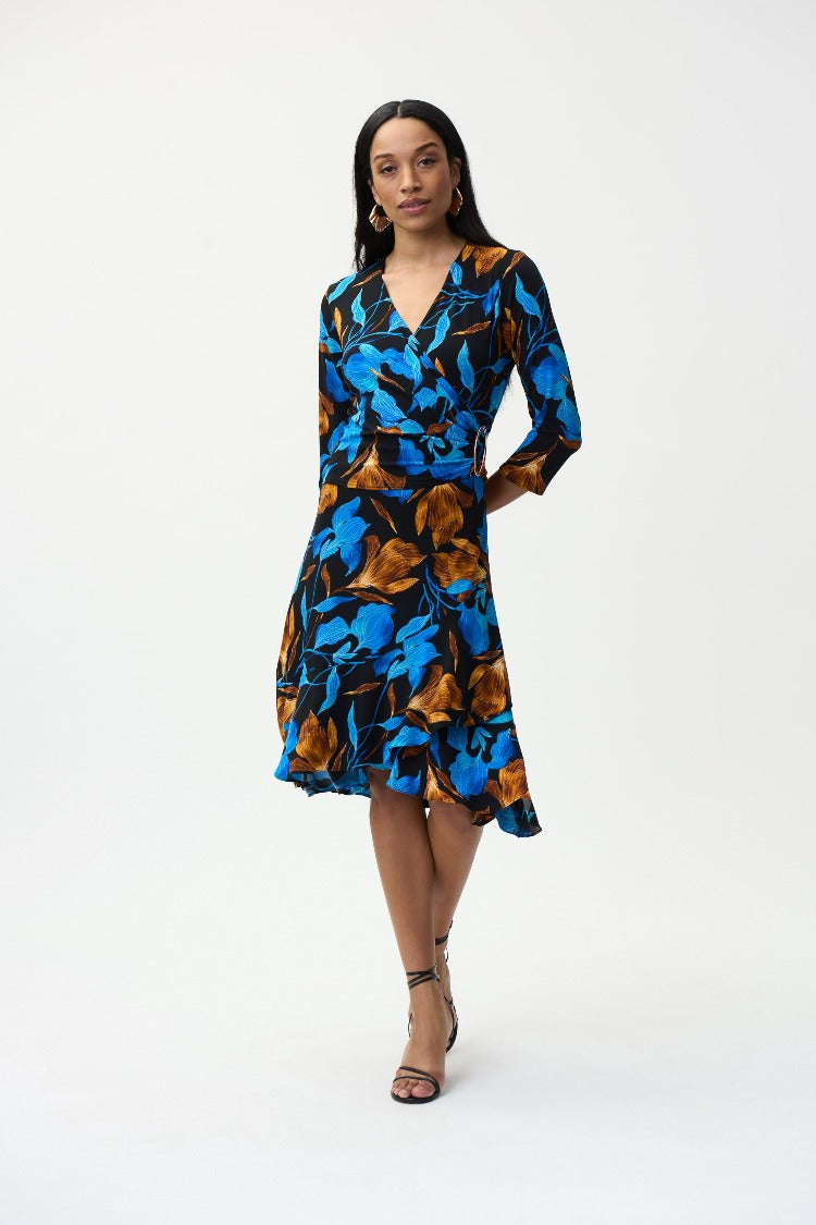 Designed in a flattering wrap style, this Joseph Ribkoff Blue Floral Print Dress, is a beautiful statement of colour. From its 3/4 sleeves and gathered waist to its ruffled hemline you will feel fabulous every time you wear it.