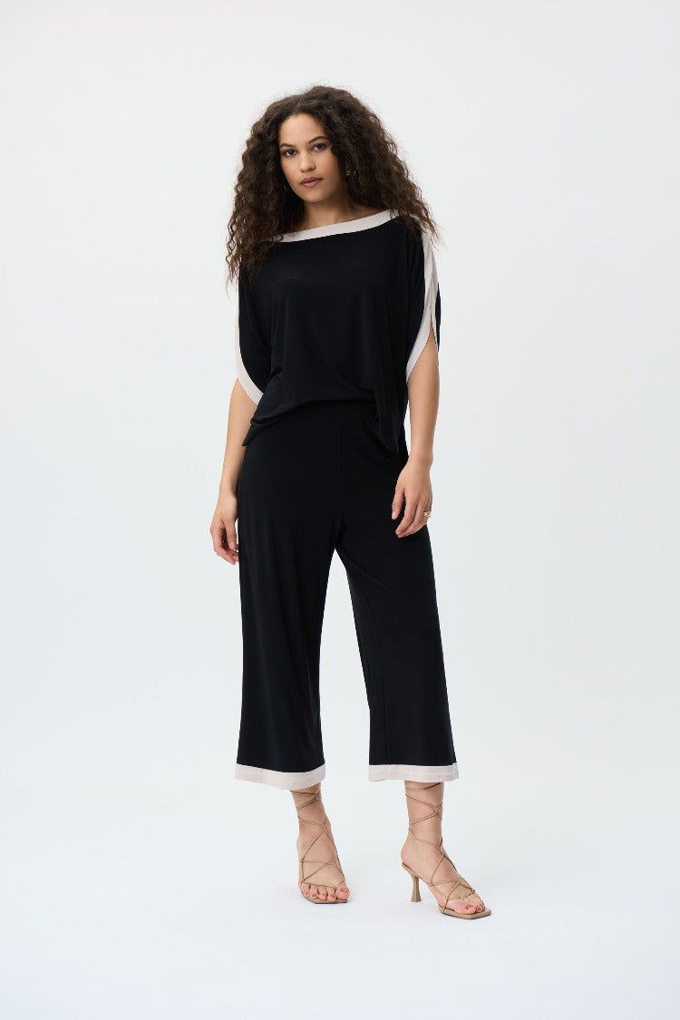 With a casual, relaxed fit and contrast trim, this stunning Joseph Ribkoff jumpsuit is sure to be a style you'll pick again and again this season. A white trim contours the neckline, sleeves, and ankles, a bold look to wear to work or for a special occasion.