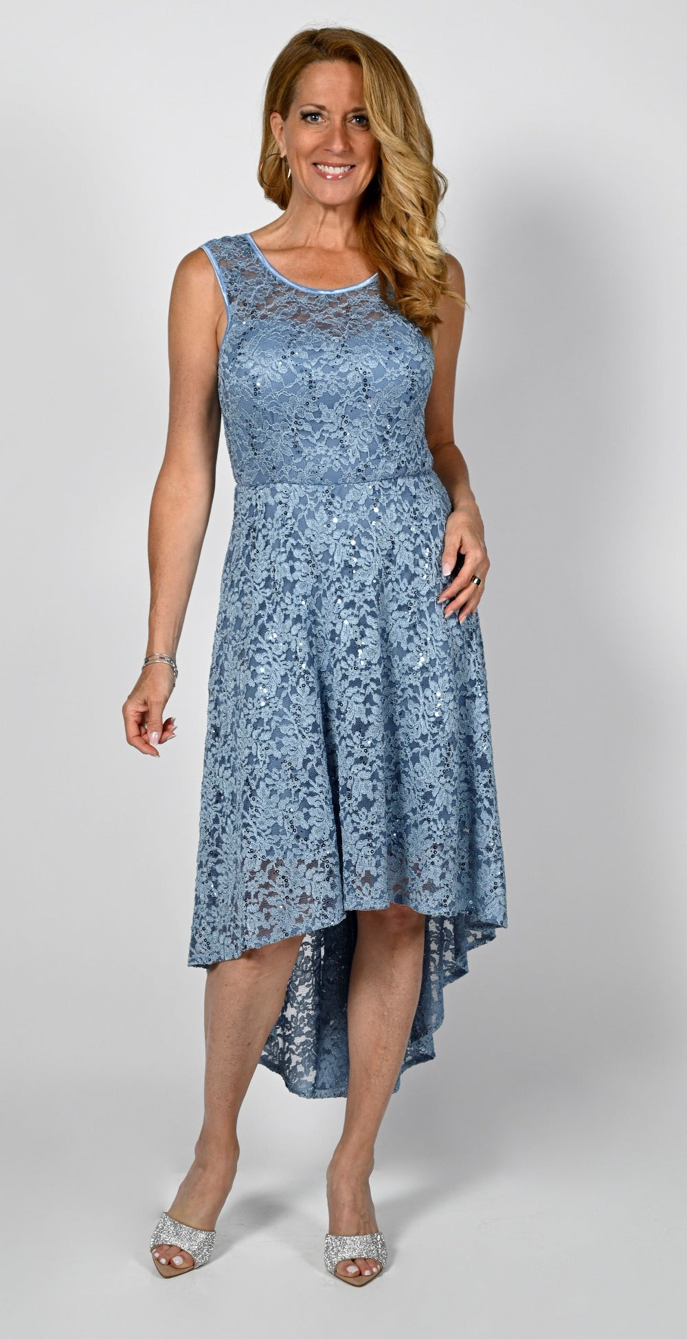 Frank Lyman Lace Dress  A simple yet classic style that gives you a beautiful silhouette is found with this Frank Lyman Lace Dress. With a bit of sequins to give a touch sparkle that will let you shine and sleeveless fit and flare with high-low hem it will look fabulous for your special occasion.