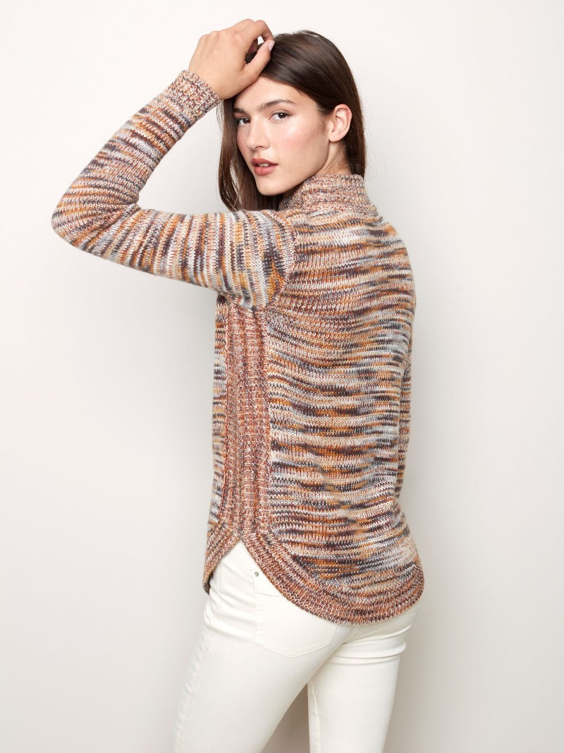 The multi earthy tones in this Charlie B knit Funnel Neck Sweater give you a great look for the season.  The simple funnel neck has long sleeves, a rounded hem and the matching hem pattern along the sides for a fun detail.  Style with a pair of skinny jeans and a high boot for a classy yet casual look.