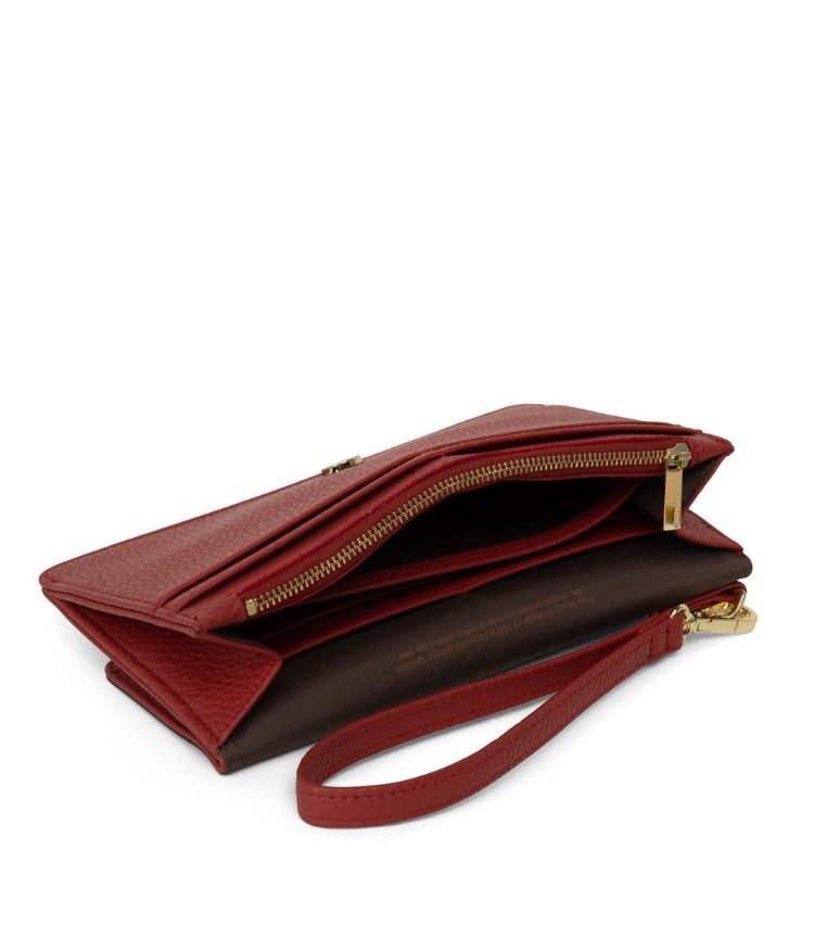 Matt & Nat CLOE Vegan Purity Wallet has a flap closure and a detachable wrist strap so you can use it as a wristlet. It is roomy enough to fit an iPhone 13 Pro Max as well as your necessities.