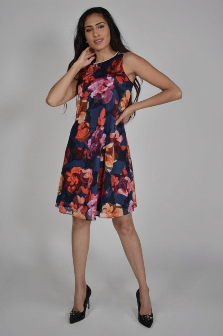 Frank Lyman Navy/Red Print Dress  This Frank Lyman Navy/Red Print Dress is vibrantly colourful with a round rhinestone neckline, gorgeous leaf overlay and timeless shift design, this dress is sure to set you apart at your next event. 
