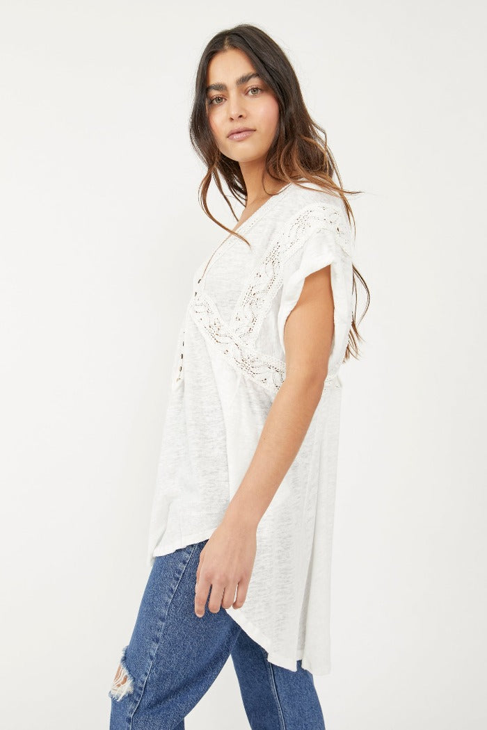 Free People Way Out There Tunic  The loveliest short sleeve tunic top with a button-front, V-neckline; Dolman sleeves; Lower back hemline with lace inserting throughout. Drapey, relaxed fit.
