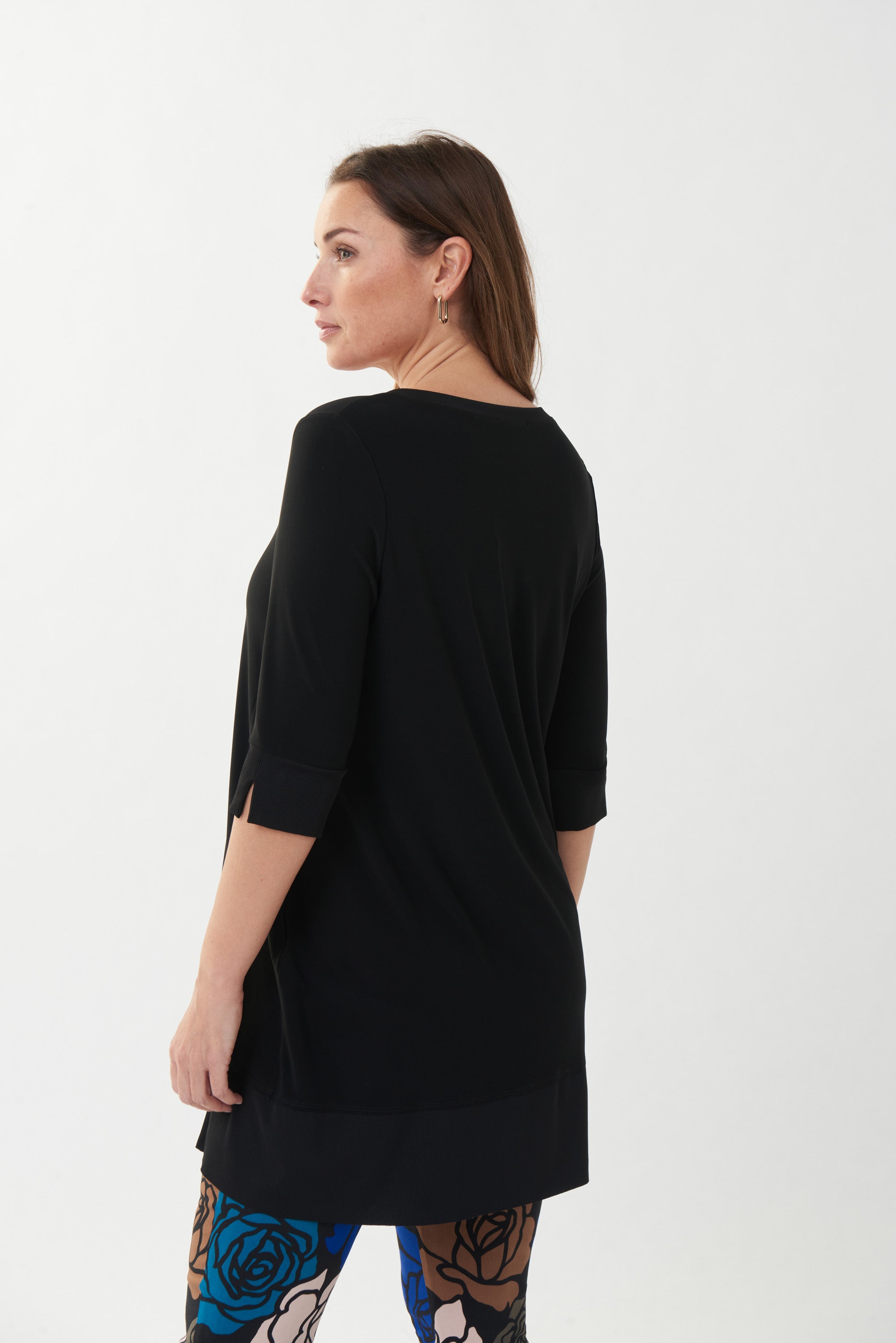 This Joseph Ribkoff V Neck Tunic is an easy piece to wear with leggings or slim fit pants. It showcases ribbed detailing at the neck, 3/4 length sleeves and hem, as well as a high low hemline and double front notches. 