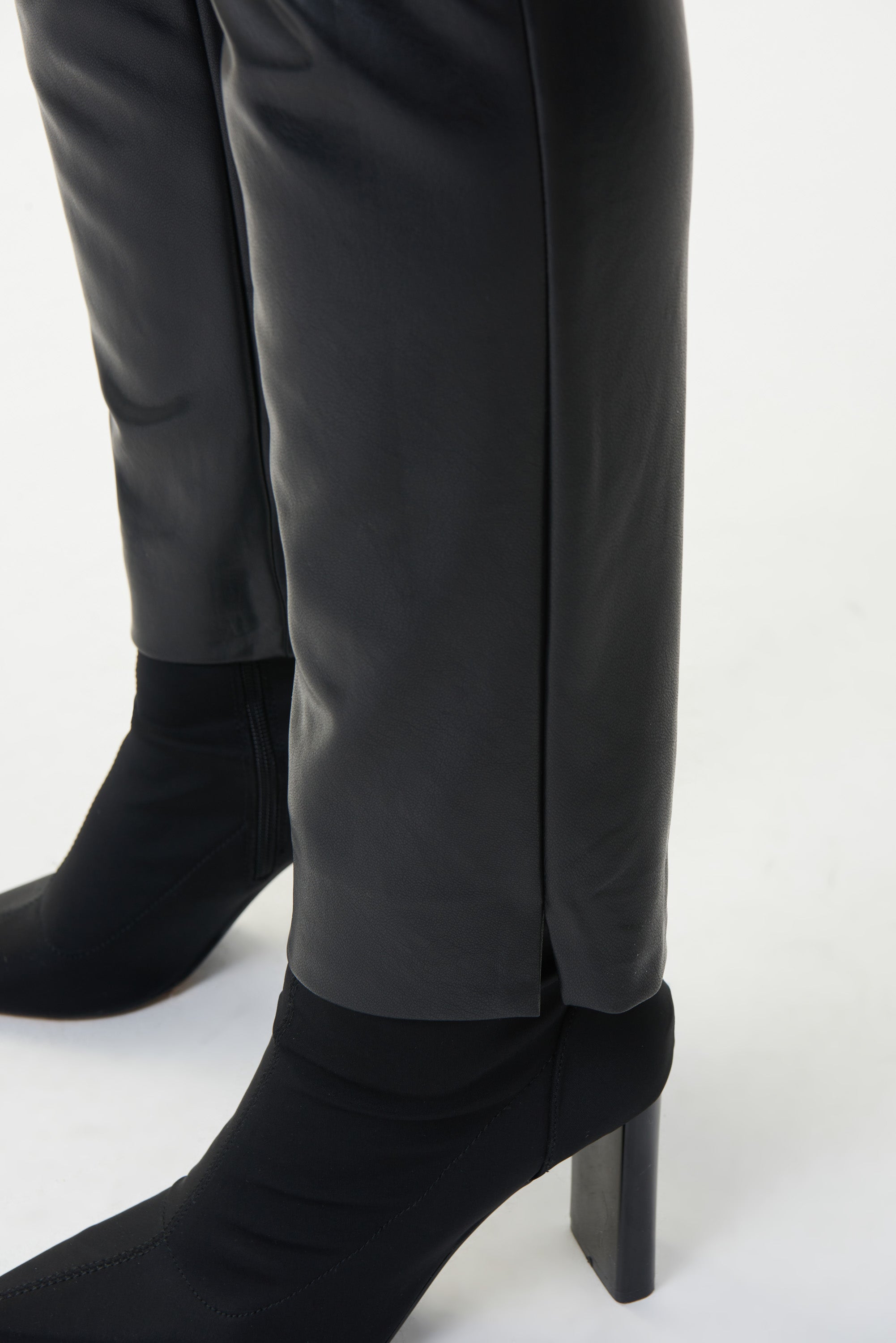 These Joseph Ribkoff Pleather Dress Pants are a chic choice for work or play. These pull on, slim fit, high rise pants feature a  2.5 inch waistband that stays securely in place, a metal Joseph Ribkoff signature tag at the hip and notched ankle to show off your shoes.