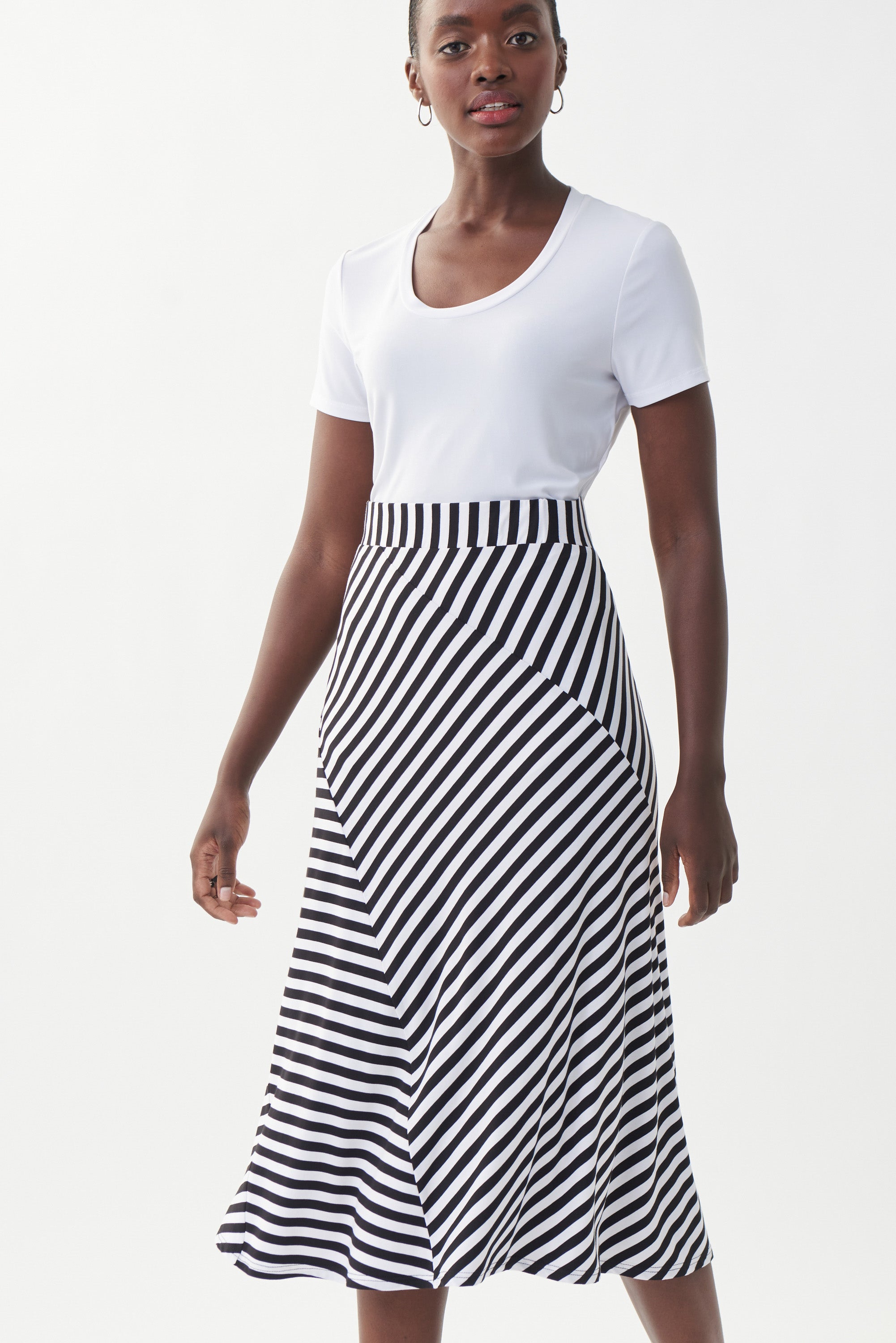 This lovely Joseph Ribkoff Stripe Skirt features a comfortable elastic waist, lightweight fabric and diagonally stitched panels, offering a stylish and visually unique twist on a classic. Proudly made in Canada.