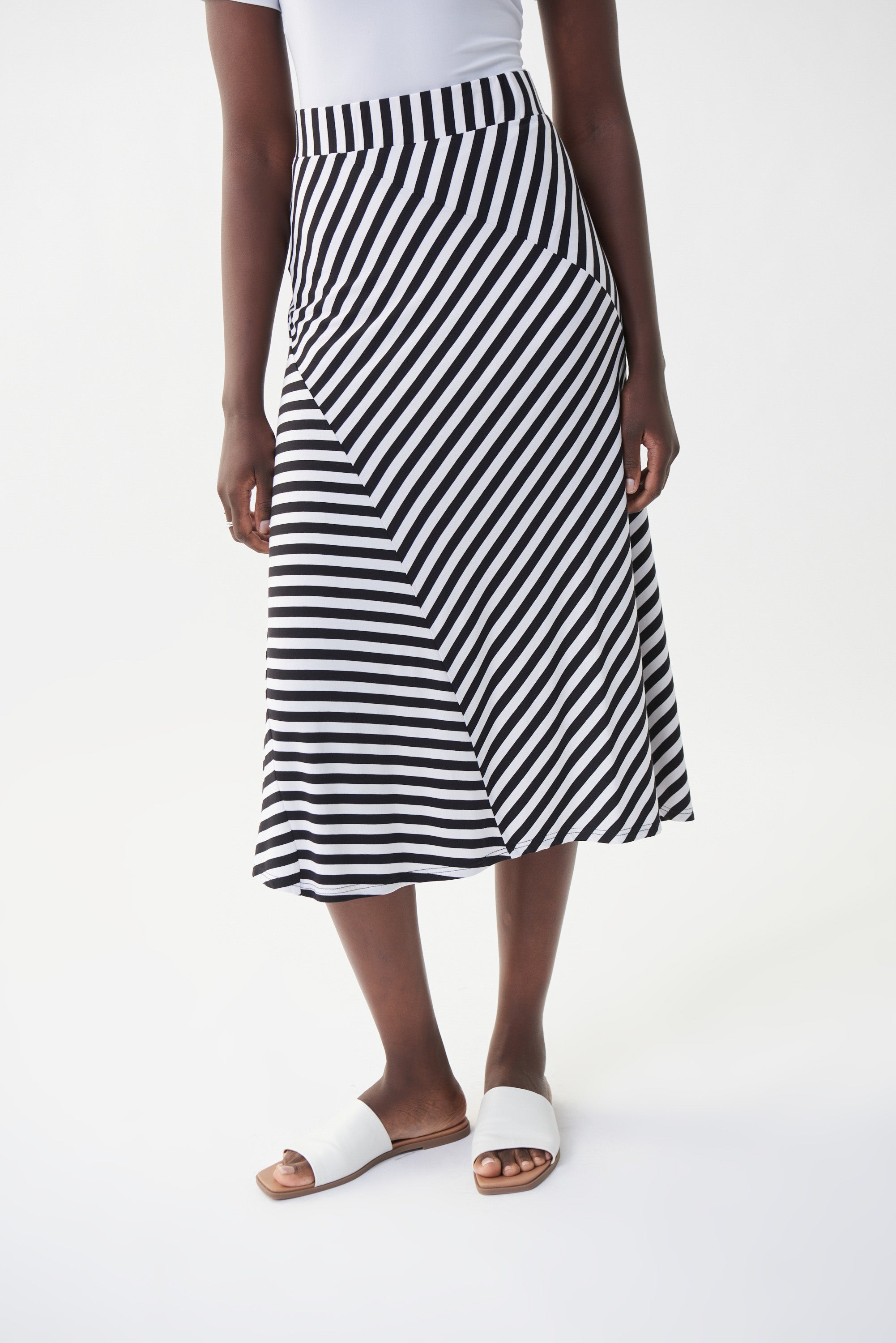 This lovely Joseph Ribkoff Stripe Skirt features a comfortable elastic waist, lightweight fabric and diagonally stitched panels, offering a stylish and visually unique twist on a classic. Proudly made in Canada.