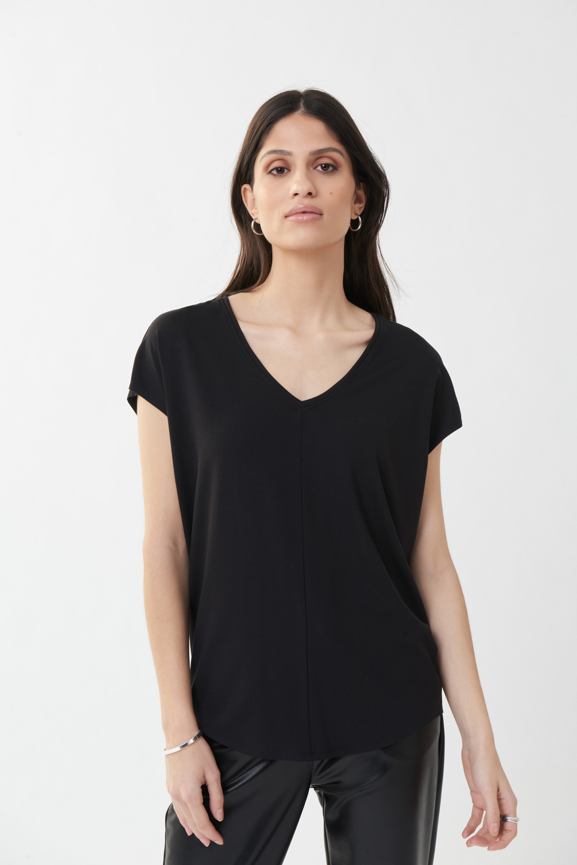 ﻿This Joseph Ribkoff V-Neck Top is a basic you need for your wardobe with a short sleeve design, vertical front stitching, a horizontal stitch in the back and an easy, relaxed fit. Style with pleather or printed pants. Proudly made in Canada.