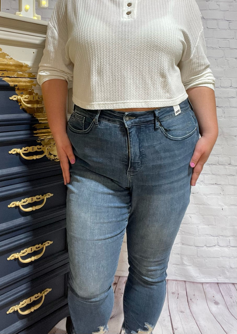 Judy Blue Plus High Waist Tummy Control Jeans  Slip into these Judy Blue Plus High Waist Tummy Control Jeans and show off those curves! These ultra flattering jeans feature a high waist tummy control top, 27" rise, a distressed hem and are finished with a classic medium indigo rinse. Also available in Regular Sizes.  Style: 88425 PL