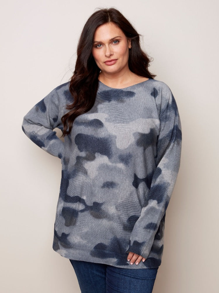 This tunic-length Charlie B Plus Long Sleeve Printed Sweater has so much for you to love.   Super comfy material, a rounded hem, ribbed sleeves as well as an eye-catching tie-dye print and it even has pockets! 