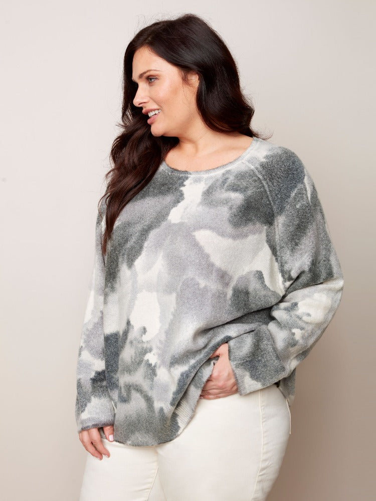 Get into your fashion groove with this tie-dye inspired Charlie B Plus Reversible Printed Crew Neck Sweater. This sweater is so versatile with a relaxed fit, roomy raglan sleeves and a classic crew neckline. The reversible option allows you to wear it inside and out!