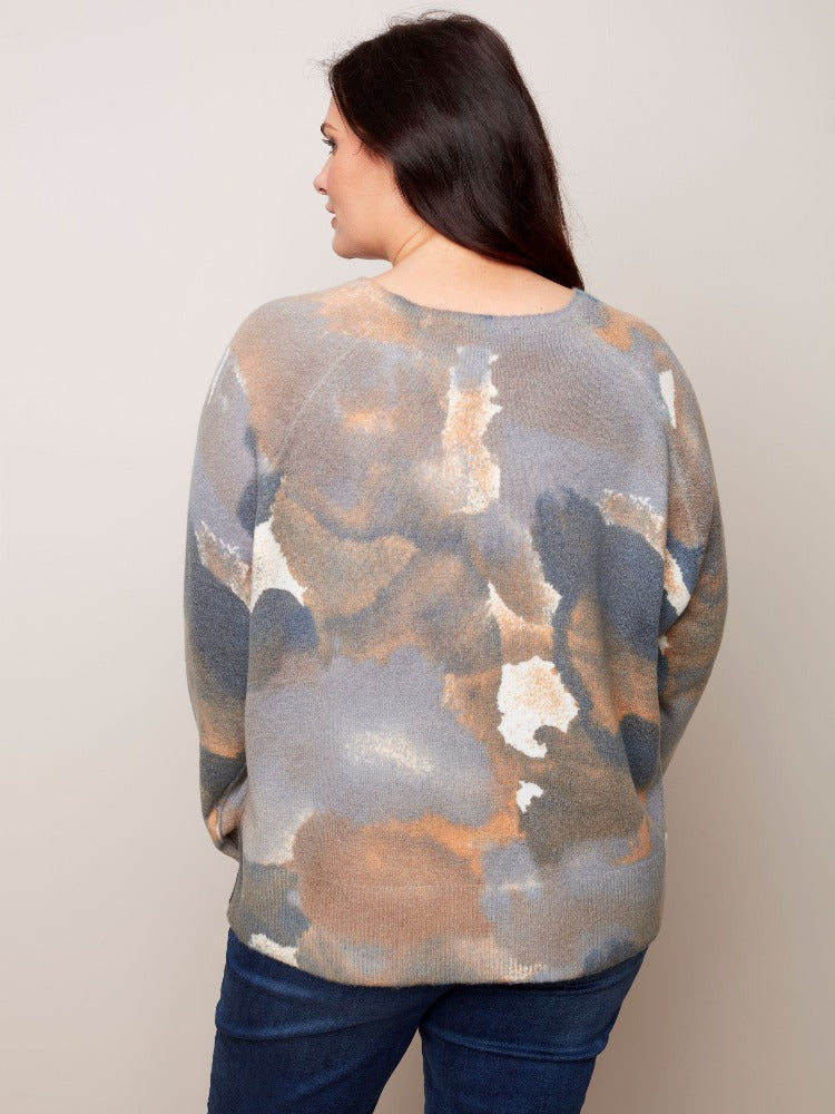 Get into your fashion groove with this tie-dye inspired Charlie B Plus Reversible Printed Crew Neck Sweater. This sweater is so versatile with a relaxed fit, roomy raglan sleeves and a classic crew neckline. The reversible option allows you to wear it inside and out!