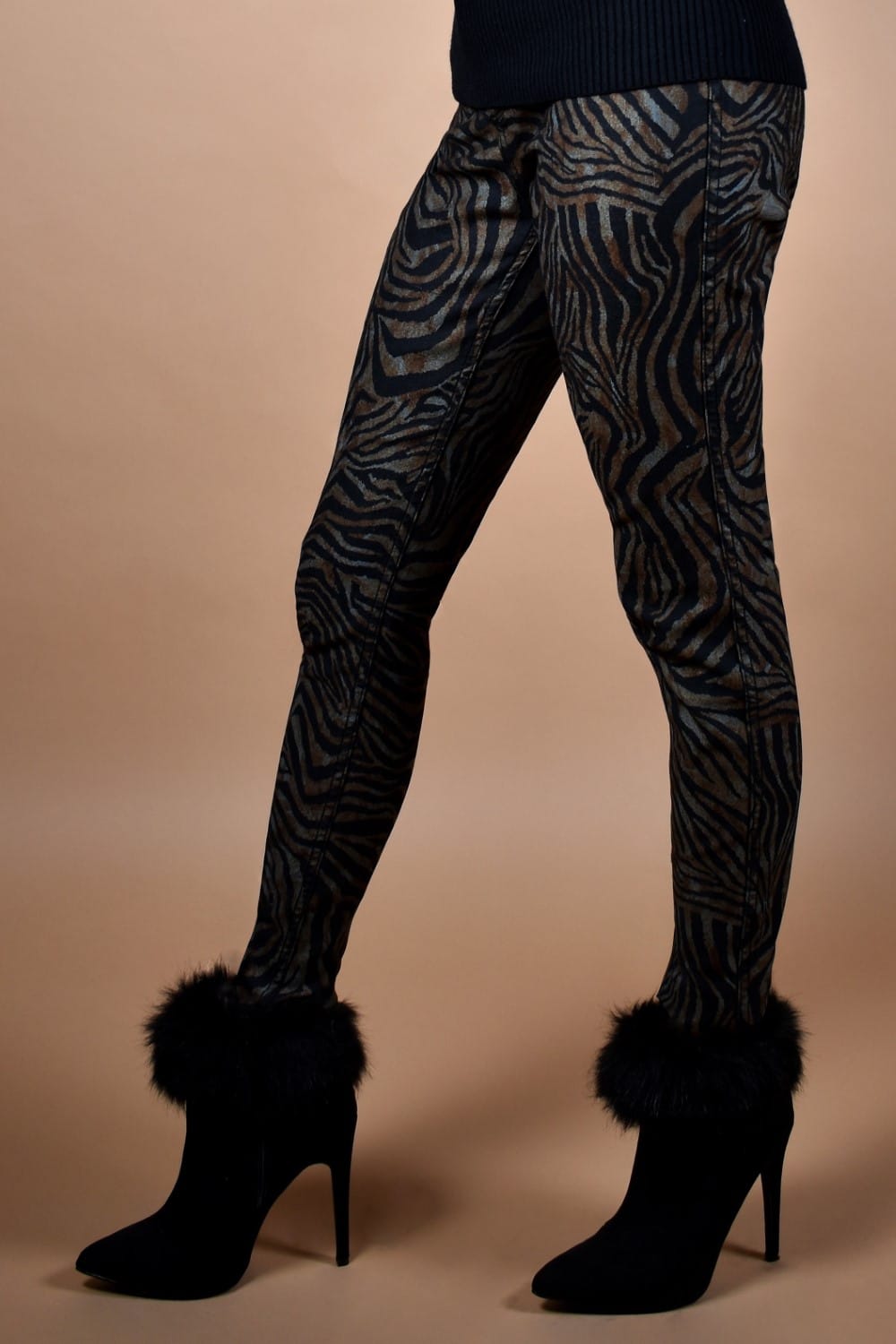 Frank Lyman Reversible Zebra Print Pant  So fierce! We can't get enough of these Zebra Print Pants from Frank Lyman! One side features a classic, solid black with faux front pockets. The other showcases a daring zebra print design, perfect for making a statement. Proudly designed in Canada.