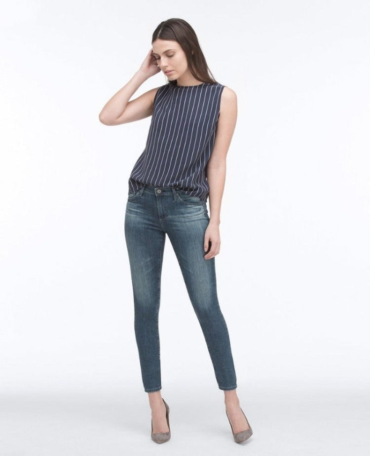 AG Medium Wash Ankle Legging  Style # PVC1389 Signature skinny, cropped ankle length Soft Japanese denim with power stretch and astounding recovery Mid blue jean has subtle whiskering and the hips and faded through the knee and set to emulate the look of natural wear Classic five pocket design Zip fly and single button closure